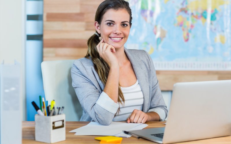 travel agent, occupation, travel, business, map, cartography, journey, destination, world map, exploration, vacations, tourist, happy, smiling, cheerful, laptop, notebook, technology, computer, wireless, portrait